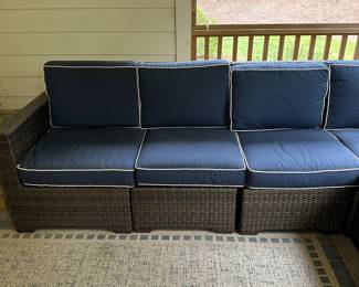 P36 - $1750. Frontgate Palermo Collection. 7 piece wicker modular sectional. Measures 103" wide (each side) x 31" deep x 32" tall. Overall in excellent condition! (One cushion has a stain but it comes with 2 replacement cushions.) Moves in 7 pieces. 