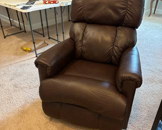 P51 - $150. 2017 La-Z Boy rocking recliner faux leather. Has some ware on head rest. Measures 26" wide x 33" deep x 39" tall