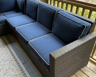 P36 - $1750. Frontgate Palermo Collection. 7 piece wicker modular sectional. Measures 103" wide (each side) x 31" deep x 32" tall. Overall in excellent condition! (One cushion has a stain but it comes with 2 replacement cushions.) Moves in 7 pieces. 