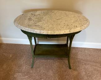 P52 - $30. Side Table Marble and wicker base. Measures 33.5" wide x 21" deep x 30" tall. (Marble is in great condition - wicker is aged with a lot of wear.)