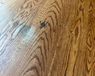 P4 - $400. Solid Wood Trestle style dining table. Has stain on the top but it's in the finish not the wood - wood is *not* warped.  Measures 48" wide x 34" deep  x 30.5" tall. 2 leaves slide into the ends and add 24" total (12" each leaf). Quality Construction! Beautiful piece - easy refinish project. 