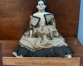 P108 - $200. Antique Doll with Greiner Label. Wax over Paper Mache Head, leather arms, cloth body. Dress has been repaired over the years. Beautiful antique condition. 
