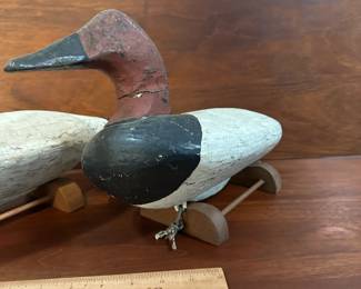 P97 - $150 Each. 2 Available (multiple photos to show angles) Unsigned Canvasback Duck Decoys. Carved wood with some age on them! Great paint. Overall very good vintage condition. One has crack around the neck area. Both have metal rings on the bottom and come with photographed stands. 