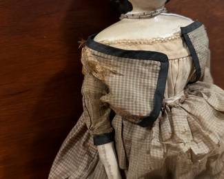 P108 - $200. Antique Doll with Greiner Label. Wax over Paper Mache Head, leather arms, cloth body. Dress has been repaired over the years. Beautiful antique condition. 