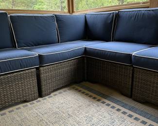 P36 - $1750. Frontgate Palermo Collection. 7 piece wicker modular sectional. Measures 103" wide (each side) x 31" deep x 32" tall. Overall in excellent condition! (One cushion has a stain but it comes with 2 replacement cushions.) Moves in 7 pieces. 