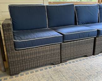 P36 - $1750. Frontgate Palermo Collection. 7 piece wicker modular sectional. Measures 103" wide (each side) x 31" deep x 32" tall. Overall in excellent condition! (One cushion has a stain but it comes with 2 replacement cushions.) Moves in 7 pieces. 