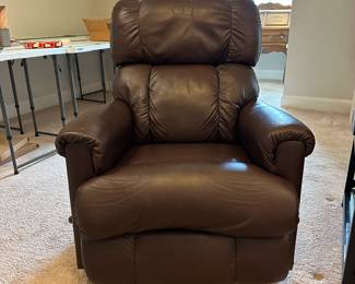 P51 - $150. 2017 La-Z Boy rocking recliner faux leather. Has some ware on head rest. Measures 26" wide x 33" deep x 39" tall