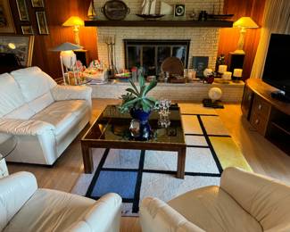 2 Italian white leather, swivel chairs with rounded backs
matching white leather couch . Gorgeous! Vintage Henredon smokey mirrored coffee table too. Also has a matching sofa table as well (in living room, with the decanters on it)
