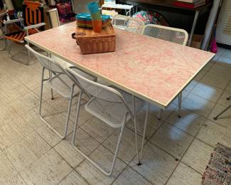 Very cute pink top, white wrought iron, hairpin leg table with four metal vintage folding chairs. Outdoor? 59x30x29"