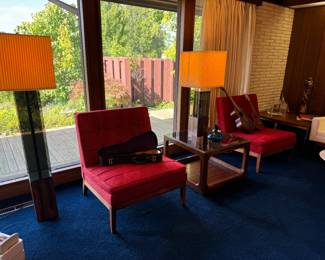 Pair of red Knoll upholstered (crunchy) armless club chairs. Pictured here are 2 ukuleles and a child's vintage guitar.