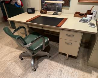 a vintage “Tank” desk (Tanker). Nicknamed this because the metal desk is virtually indestructible. Awesome matching vintage chair too, with chrome propeller base! Desk is 72x36x29"