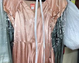 This is a beautiful heavy pink satin gown from 40-50's. Under that is a green one from the 30's. and beneath that is a black fab dress form 40's.
