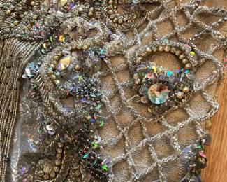 Detail of close up of a beaded show stopper belly dance skirt; Set Bra, skirt $ belt, Head piece, veil and shoulder cape.