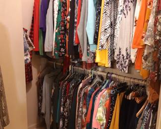 Two closets full of ladies clothing.