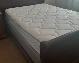 Full size dark wooden sleigh bed