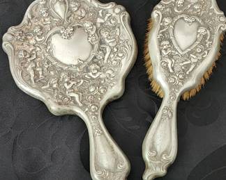 Ornate cherub mirror and brush