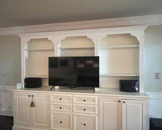 9 feet 2 inch wide by 7 foot 2 inch tall entertainment center/storage unit and speakers (tv not for sale).
