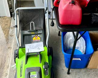 How ironic.  Electric lawnmower next to a gas can.