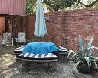 Concrete patio table and benches with custom black and white cushions. Patio table and benches pulled from the Estate