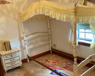 Twin bed with canopy, bedside table, kids books