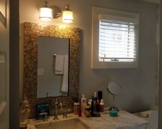 Beautiful bath vanity; handsome mirror; vanity light