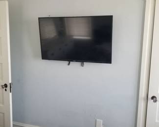 Flat screen TV with wall bracket