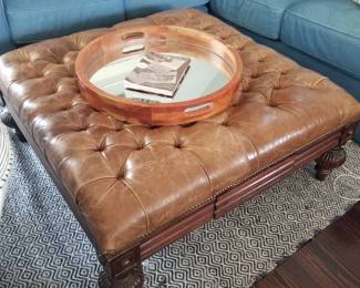 Tufted leather ottoman/coffee table; area rug
