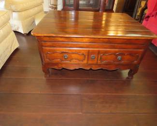Solid wood coffee table with coctail sleves and storage drawers.