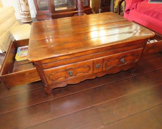 Solid wood coffee table with coctail sleves and storage drawers.