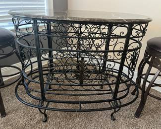 Wrought Iron Marble Top Bar with 4 swivel bar stools with leather seats. 
Has wine bottle storage. 