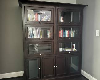 C21 - $250. Dark Wood Storage Bookcase with Barrister Doors (Lift & Slide) Measures 61.25" wide x 20.25" deep x 70.5" tall. Moves in 4 pieces. Top Crown. Each Bookcase. Base.