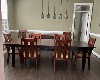 C9 - $550. Ethan Allen Dining Room Table with 8 chairs. Horizons Collection. This photo is with 2 additional leaves in. Measures 42" wide x 70" long x 30.25" tall. Each leaf adds 18" so table extends up to 106". Very good used condition. Shows minor wear I would expect with use. Very sturdy!