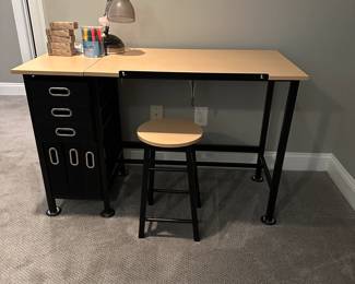 C58 - $25 small desk from AC Moore with fabric baskets. Can adjust for a standing desk. Comes with stool. Measures 47.25" wide x 23.5" deep x 30.5" tall.