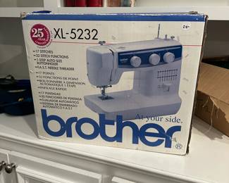 C78 - $25. Brother Sewing Machine XK-5232. Has been used but all pieces appear to be in the box.