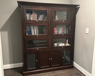 C21 - $250. Dark Wood Storage Bookcase with Barrister Doors (Lift & Slide) Measures 61.25" wide x 20.25" deep x 70.5" tall. Moves in 4 pieces. Top Crown. Each Bookcase. Base.