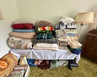 Bed comforters, blankets, tablecloths.