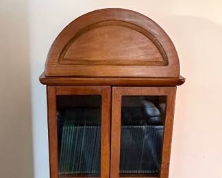 Arched display cabinet for holding CD's & DVD's.