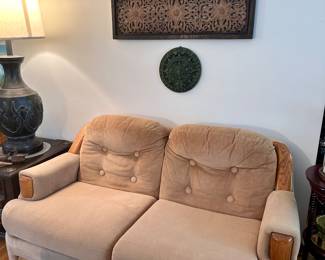 Comfy loveseat couch with wood trim.