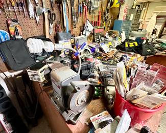 Workbench & pegboard full of tools.