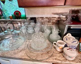 Pressed glass serving pieces and lidded jars.