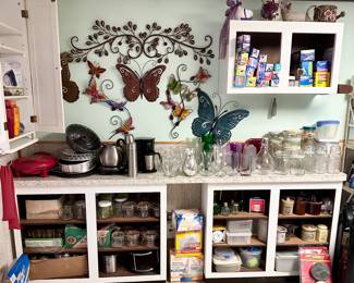 Laundry room filled with metal wall decor, jars, canisters, cleaning products, and just stuff.