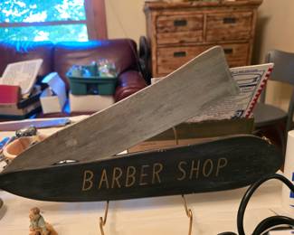 This wood sign is functional in that the razor can be removed and replaced into the sheath.