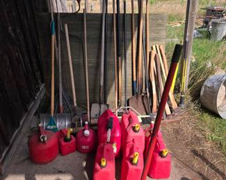 Gas Cans, lots of axes, picks, rakes, more hand implements.