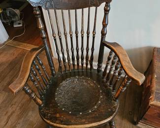 Beautiful antique rocker with an ingrained face in the seat