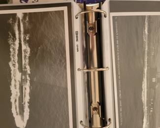 A binder full of Navy Photographs.