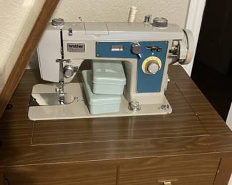 Vintage Brother sewing machine in cabinet