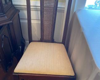 On of the arm less mahogany dining chairs.