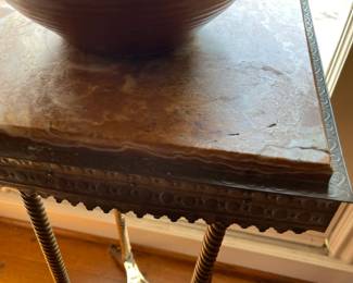 Apron and stretcher detail of the brass plant stand