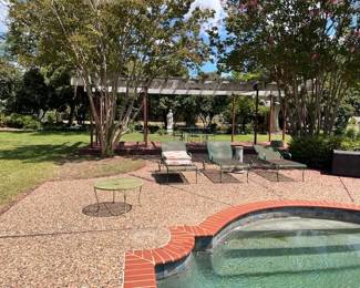 Garden loungers, table and statue in the background