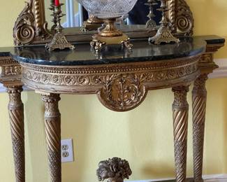 A close look at the antique console table with gold leaf and black marble top, Circa 1800